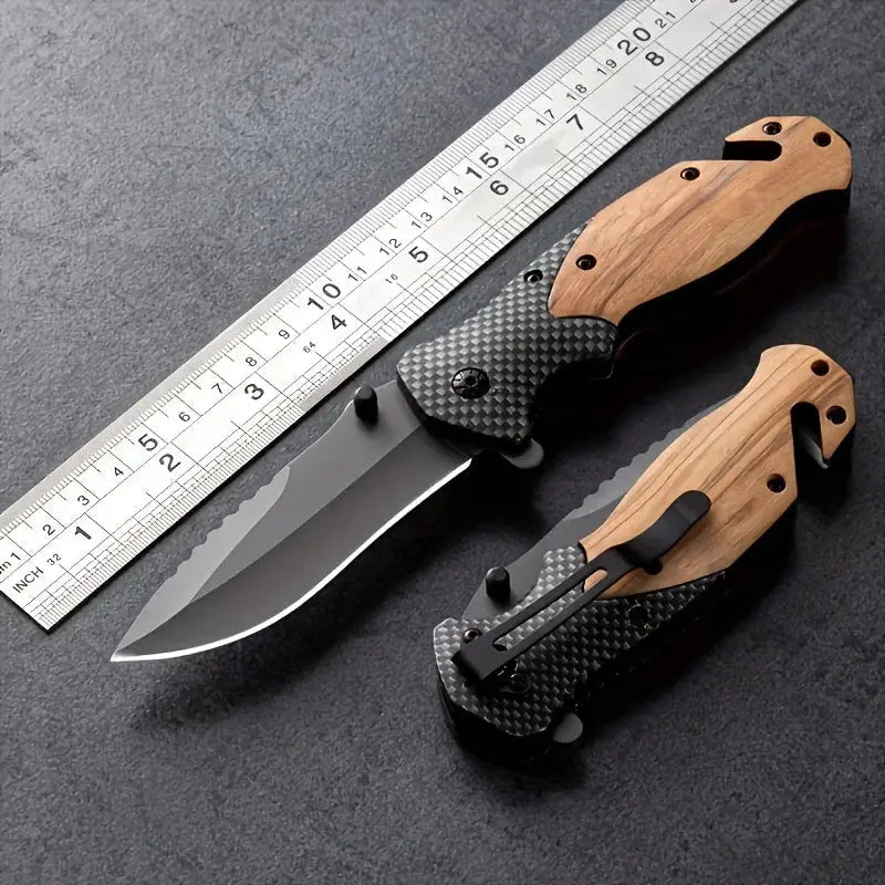 Folding knife with a partially serrated stainless steel blade, wooden and carbon fiber-patterned handle, placed against a bundle of black braided rope.